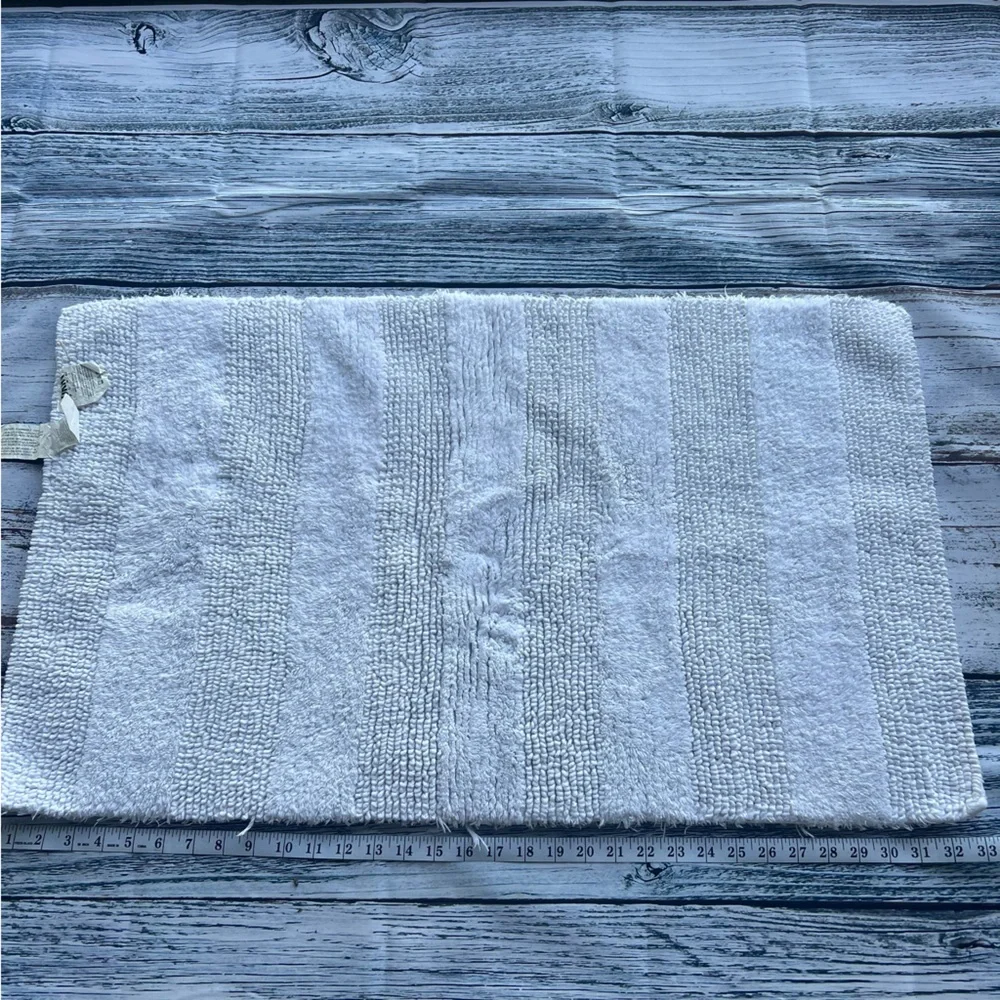 DKNY white bathroom rug 33in x 19in EUC